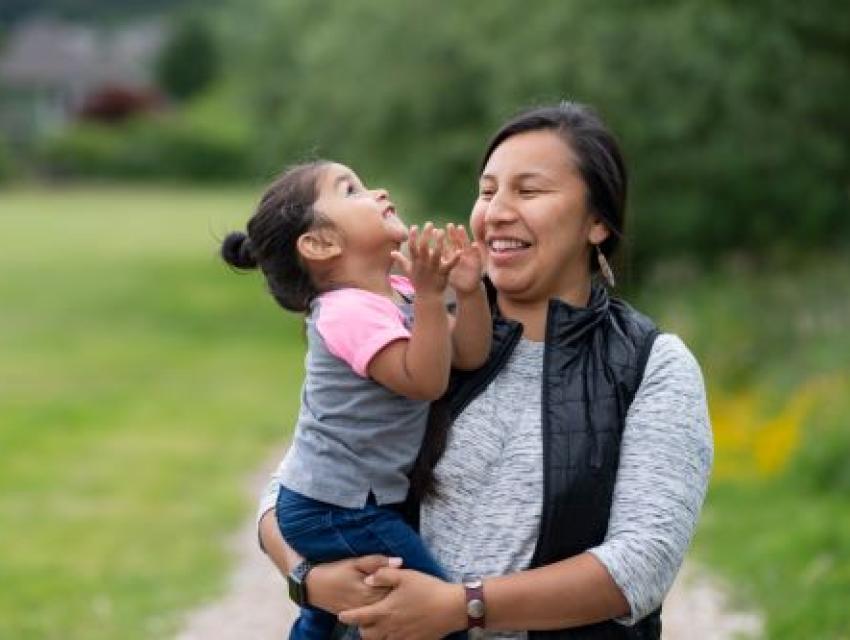 woman holding a little girl and smiling